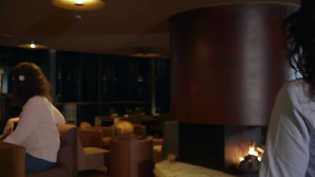 Woman entering in a bar. Steady cam shot, following a woman