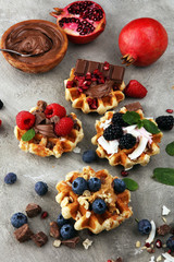 Belgian waffles with pomegranate and raspberries, homemade healthy breakfast with mint