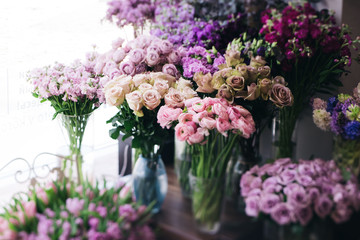 Fresh blossoming flowers at at the florist shop (roses, ranunculus, tulips, carnations)