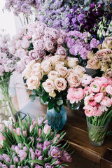 Fresh blossoming flowers at at the florist shop (roses, ranunculus, tulips, carnations)