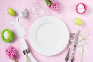 Easter romantic dinner. Elegance table setting spring pink flowers on pink linen tablecloth. Top view.