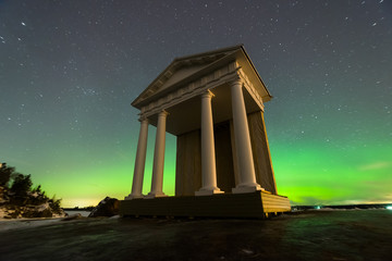 alcove in antique style against aurora borealis (polar lights) in the background