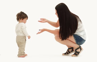 Portrait of a happy family that teaches a child to walk