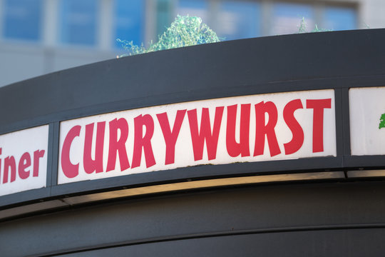Currywurst restaurant signage. Currywurst is a fast food dish of German origin consisting of pork sausage seasoned with curry ketchup