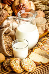 Assortment of baked bread on wooden table background