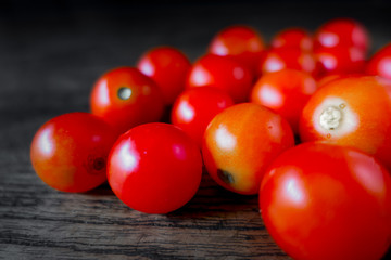 Red Cherry Tomatoes closeup on dark wood Healthy good vegetable food