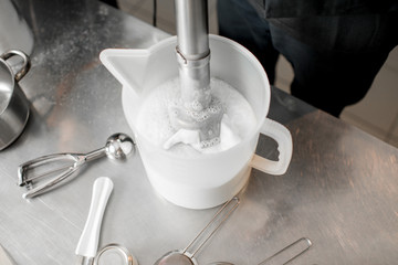 Mixing milk with sugar and cream for ice cream production