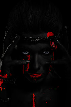 Black skin effect. girl with a bloody face, with white skin and a wreath on her head. barbed wire