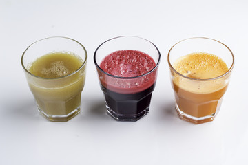 carrot, apple and beet juice on white background.