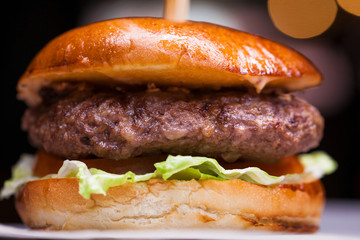 Tasty grilled prawn and beef burger with lettuce