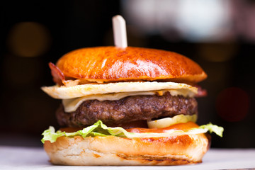 Tasty grilled prawn and beef burger with lettuce