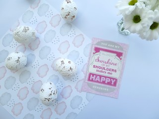 Spring celebration card, Easter eggs and white flowers