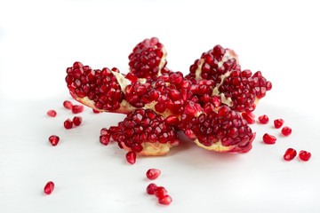 Cut-up dissected tasty garnet fruit pomegranate with seeds isolated