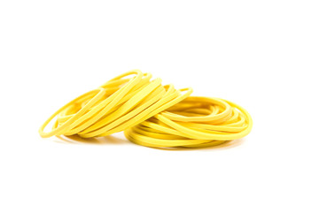 Pile of yellow rubber bands isolated on white background. Packaging supplies and accessory. Thin rubber bands.