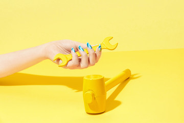 Nails Design. Hand With Colorful Nails On Yellow Background