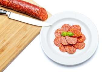 Italian Salami or spanish chorizo on plate white background