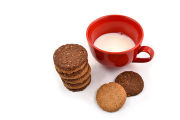 Red mug with milk and biscuits stock images. Cup of milk on a white background. Red mug of milk with cookies