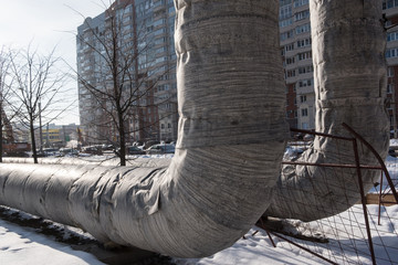 Pipes of hot water supply temporarily installed above the ground during the construction of a...