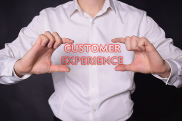 A businessman shows an inscription:CUSTOMER EXPERIENCE