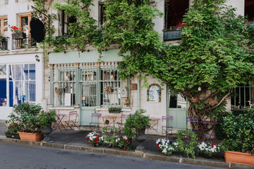 Fototapeta na wymiar Cozy street with tables of cafe in Paris, France
