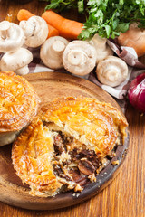 Fresh beef stew pie on a cutting board