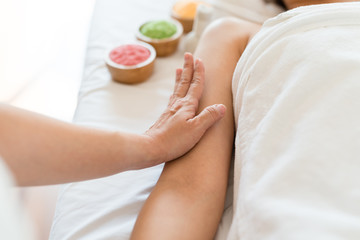 Fototapeta na wymiar Asian girl relaxing having arm massage in a spa salon, close up view