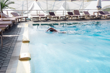 the man is swimming in the pool