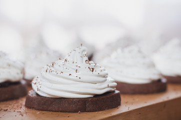 chocolate cake with egg white cream on the wooden board