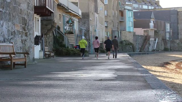 People running at the coast of st.malo (bretagne)