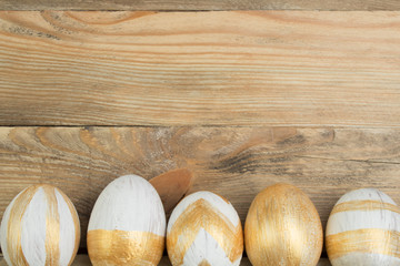 Fototapeta na wymiar Happy Easter. Painted eggs on wooden table. Top view.