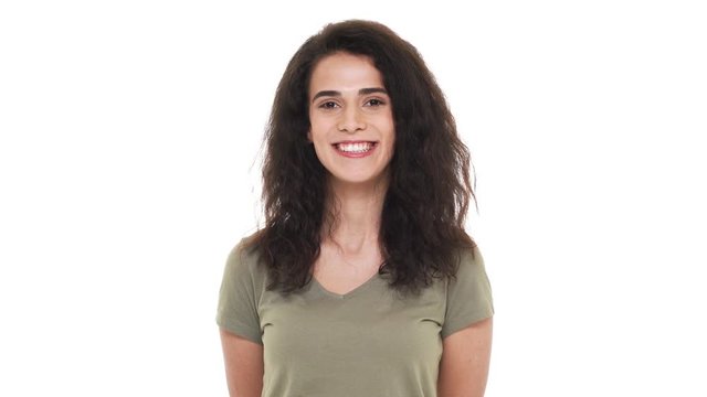 Portrait of attractive woman 20s with long curly hair smiling broadly with white teeth and expessing good mood, isolated over white background. Concept of emotions