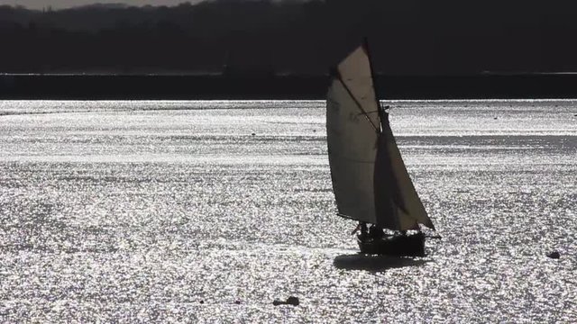 Sailing boat is passing by in a wonderful light, atmosphere in Bretagne