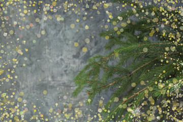 Christmas composition of fir branches and berries of viburnum on a concrete background.