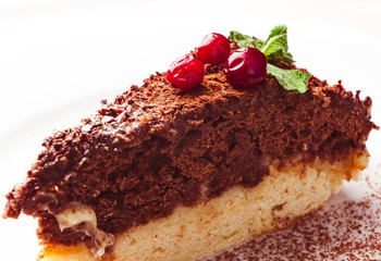 Piece of cake with cherry isolated on white