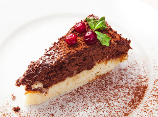 Piece of cake with cherry isolated on white