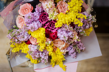 Wonderful bouquet of multi colour roses, lilac and mimosa
