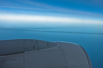 Fototapeta na wymiar Airplane engine with clear blue sky horizon in background during flight to Morocco