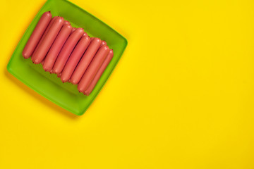 Sausages on a yellow background. Flat lay. top view.