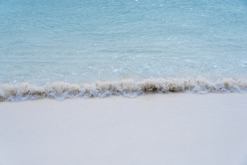 closed up clear and blue wave of the sea on white beautiful island beach
