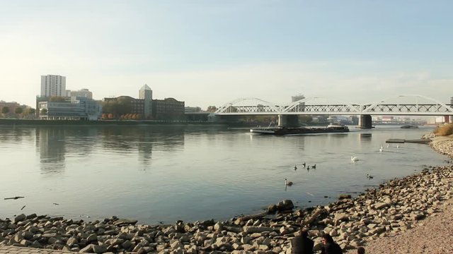 a typical ship on the rhein river is passing Ludwigshafen and Mannheim during a wonderful autumn atmosphere