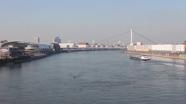 a typical ship on the rhein river is passing Ludwigshafen and Mannheim during a wonderful autumn atmosphere