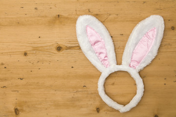 Easter bunny ears on a wooden background