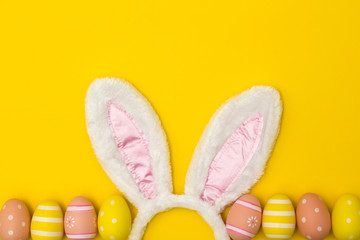 Easter holiday background with bunny ears and easter eggs
