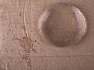 Magnifying glass on cardboard strom