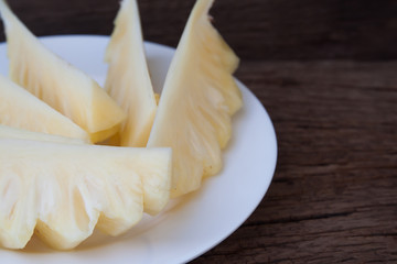 Close up sliced pineapple on wooden table