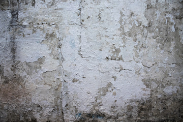 Old wall with white paint peeling off texture in black and white tone