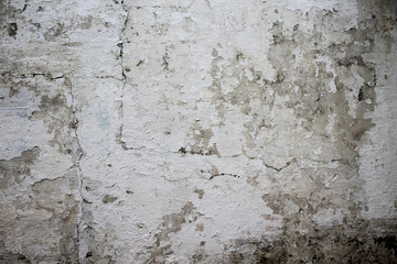 Old wall with white paint peeling off texture in black and white tone
