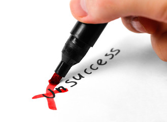 Fototapeta na wymiar Marker crossed out Un in the word Unsuccess. Close up