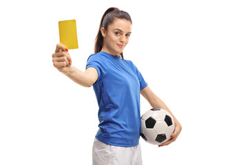 Naklejka premium Female soccer player showing a yellow card
