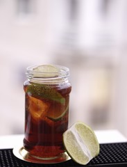 Rum and cola with lime in a jar